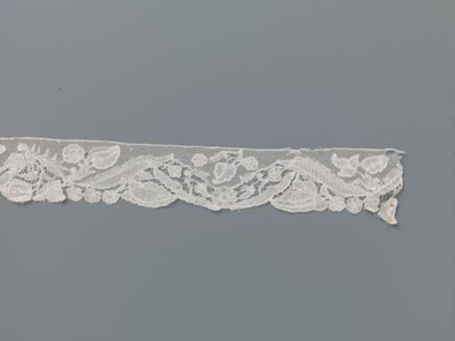 Strip of Bobbin Lace with a Wavy Band of Lanceolate Leaves and Various Different Flowers