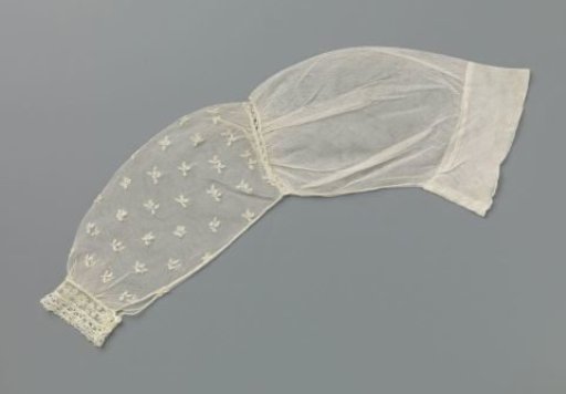 Sleeve of appliqué lace with scattered three-part leaves