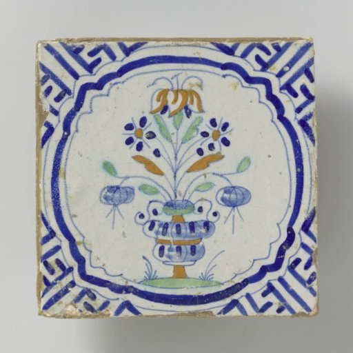 Tile with a multicolored pattern in blue, orange, yellow and green of a flowerpot framed by a bracket with meanders in the corners