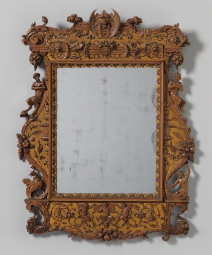 Mirror frame of palmwood with carved decoration including grotesques, volutes, satyrs, a basilisk and a triton, flowers, vines and masks.