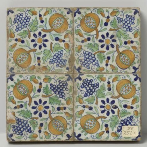Panel of four tiles with rosettes, grape clusters, and pomegranates