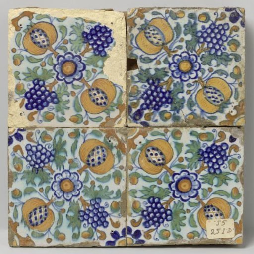 Panel of four tiles with rosettes, grape clusters, and pomegranates