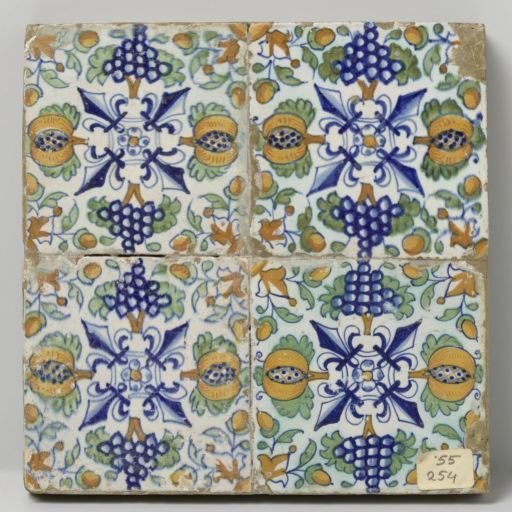 Field of four tiles with lilies, pomegranates and grape clusters