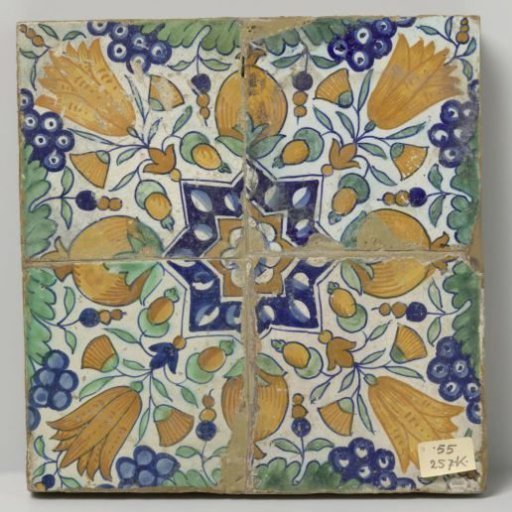 Panel of four tiles with a pattern of grape clusters, tulips, pomegranates and stars