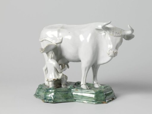 Cow with milkmaid, on a green pedestal
