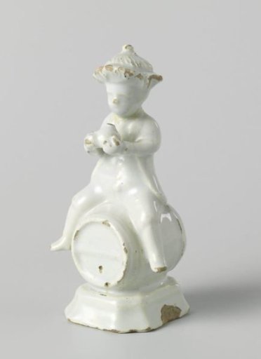 Man with hat and bottle in hand, on a barrel
