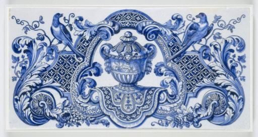 Tile with blue-painted decoration of a vase on a hanging cloth within a trefoil, surrounded by a cartouche with curling acanthus leaves and flowers