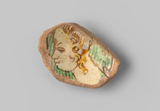 Fragment of a bowl, decorated with a woman's head turned to the left in sgraffito.