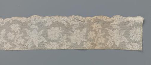 Border of bobbin lace with pear-shaped fruits on S-shaped stems with flowers