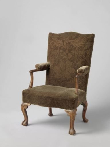 Mahogany chair on obliquely placed S-shaped legs on ball and claw, the rear legs ending in hoof feet. Seat upholstered in green velvet.