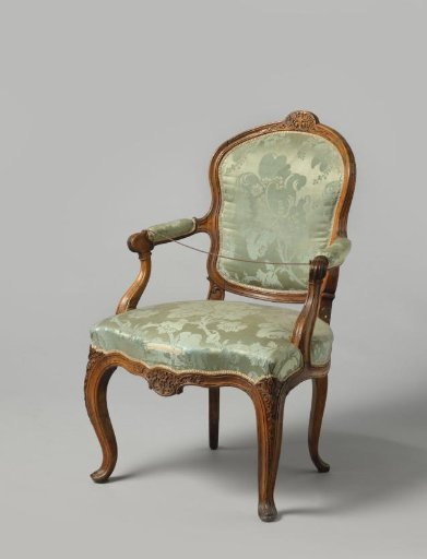 Chair upholstered in blue damask. S-shaped curved legs, carved front rail with floral work.