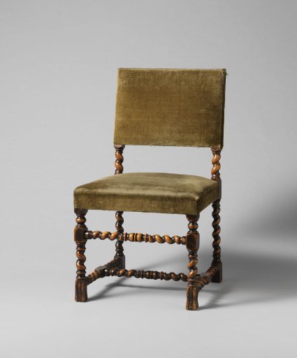 Chair of oak wood with upholstered seat. Scrolled parts.