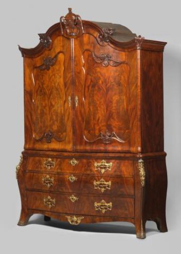 Cabinet with Arched Lower Section with Three Drawers and Two Doors in the Upper Section with Flat Panels with Mouldings and Decorated with a Medallion Head and Vase with Bow and Festoons.