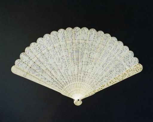 Brisé fan of ivory, fret-carved, with Chinese scenes in relief on both sides, centrally a monogram with PMH