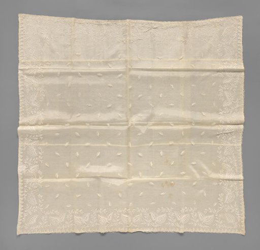 Baptismal veil of appliqué lace with blooming roses on a branch and snowballs above curved feathered leaves