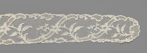 Lace cap slip with symmetrical pattern of S-shaped ornamental bands and irises