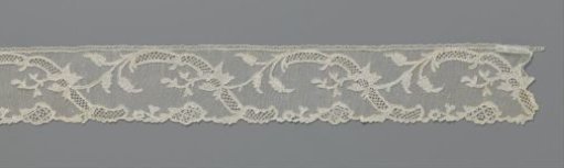 Strip of needle lace with S-shaped ornamental band and iris