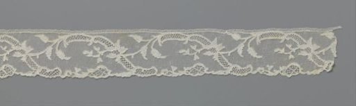 Strip of needle lace with mirrored S-shaped ornamental band and iris
