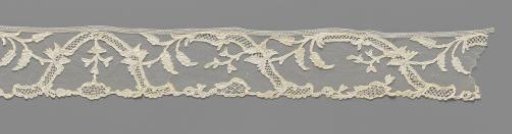 Strip of needle lace with symmetrical pattern of S-shaped ornamental bands and irises