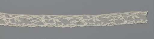 Strip of needle lace with mirrored S-shaped ornamental band and iris