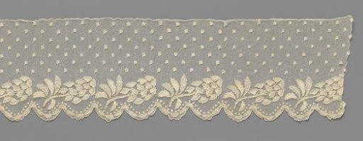 Strip of needle lace with diagonal cluster flower above two shells