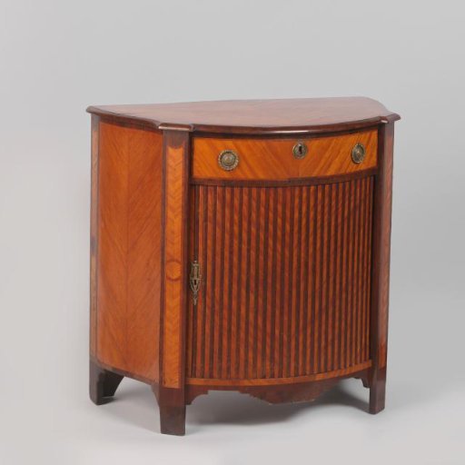 Cabinet with beaded jalousie door and drawer with marquetry in stripes and herringbone pattern. On the key plate a female figure with festoons.