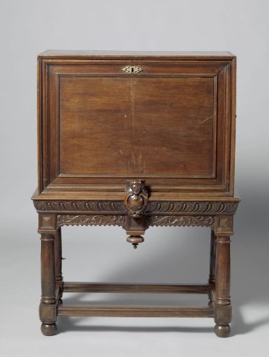 Writing cabinet of South African stinkwood (?) with a drop-leaf with profiled edge and an extendable support with a cartouche and a man's head