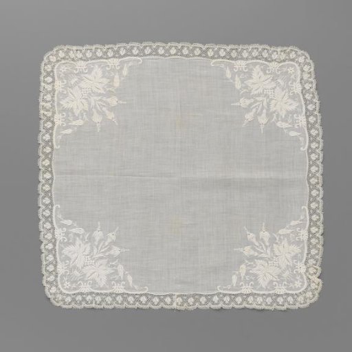 Handkerchief of batiste with a bouquet in embroidered scrolled corners and a border of machine lace