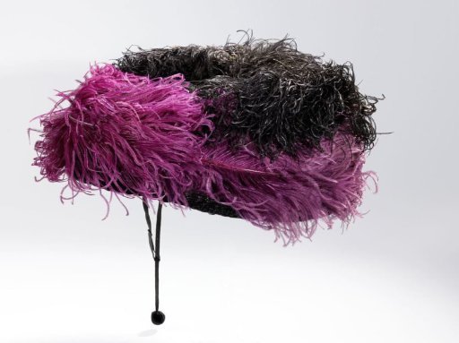 Hat of black velvet with purple and black ostrich feathers and loose veil
