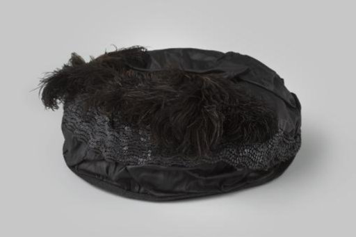 Hat of black straw lined with black moiré silk and decorated with sequins and ostrich feathers
