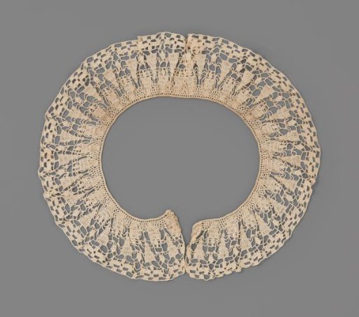 Round collar with staggered spire motifs and border of stylized flowers