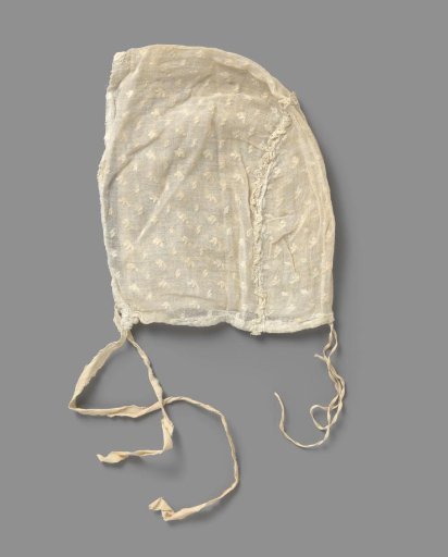 Children's cap of sheer woven white cotton with a white embroidered scattering motif, edged at the back with lace; front and back two ribbon bows
