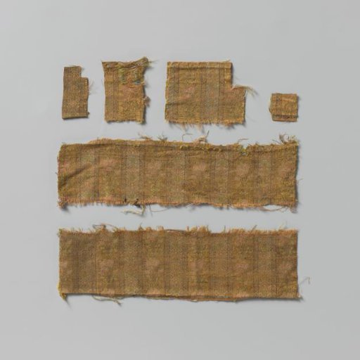 Fragment of silk brocade fabric with a pattern of pastel-colored flowers on a striped ground