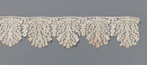 Strip of bobbin lace with thistles in a flowerpot
