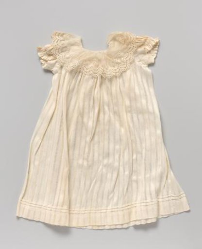 Dress or apron of piqué with openwork stripes