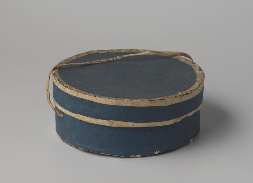 Round hatbox of cardboard, covered with dark blue paper with white piping