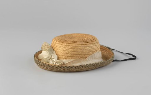 Hat of natural straw with upturned brim and white ribbon