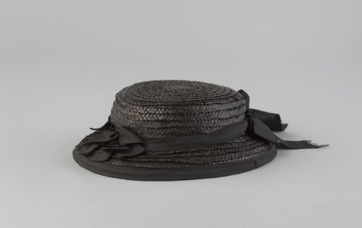 Hat of black straw with drooping brim and black ribbon