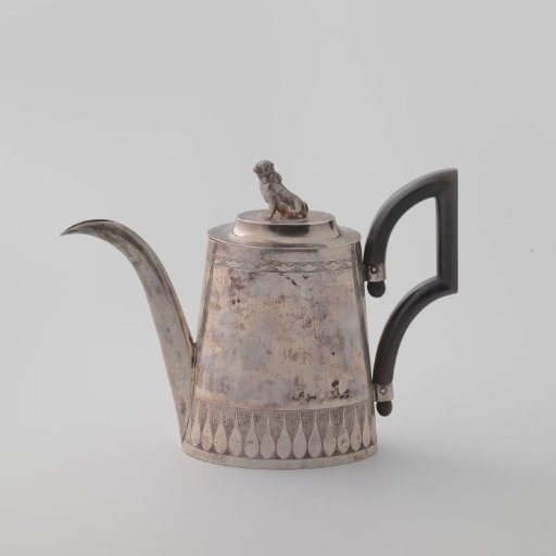 Silver teapot with an ebony handle, the body a band with smooth drop motifs on a rough ground, lid with a dog