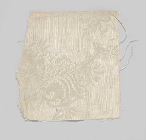 Fragment of white and silver silk damask with a pattern of pomegranates