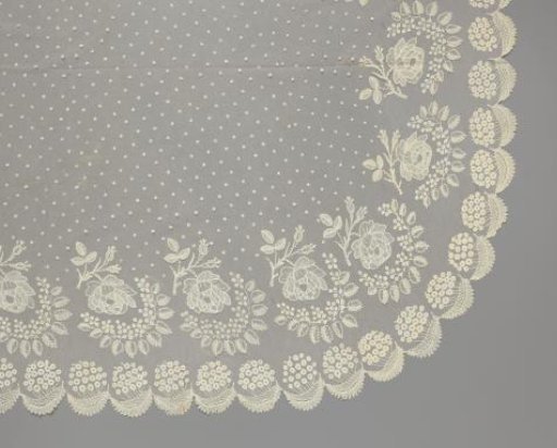 Cradle curtain or skirt of applied lace with Redout roses on a branch and snowballs above curved feathered leaves