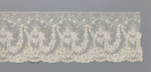 Strip of needle lace with standing oval medallions in a rich pattern of floral garlands