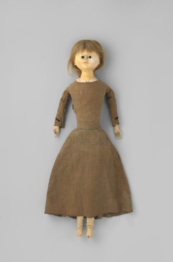 Wooden doll, partially painted, with a grey cotton dress