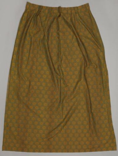 Curtain with a pattern of leaves within pointed ovals in yellow on a green ground