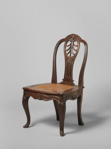 Chair with a seat of woven rattan, S-shaped diagonal front legs and seat rails decorated with stretched S-shaped moldings and foliage. upper frame with palmettes