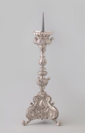 Silver candelabrum with baluster stem in five sections on triangular base on scroll feet. Decorated with medallions with Christ, Peter, and Ignatius