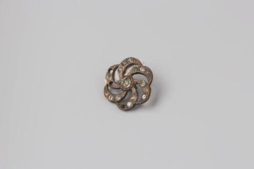 Knob of silver-colored metal and paste