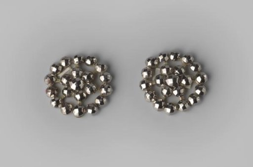 Two buttons of steel cut in diamond shape