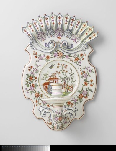 Wall sconce with flower sprays and a pavilion in a fenced garden