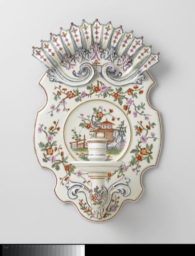 Wall sconce with flower sprays and a pavilion in a fenced garden